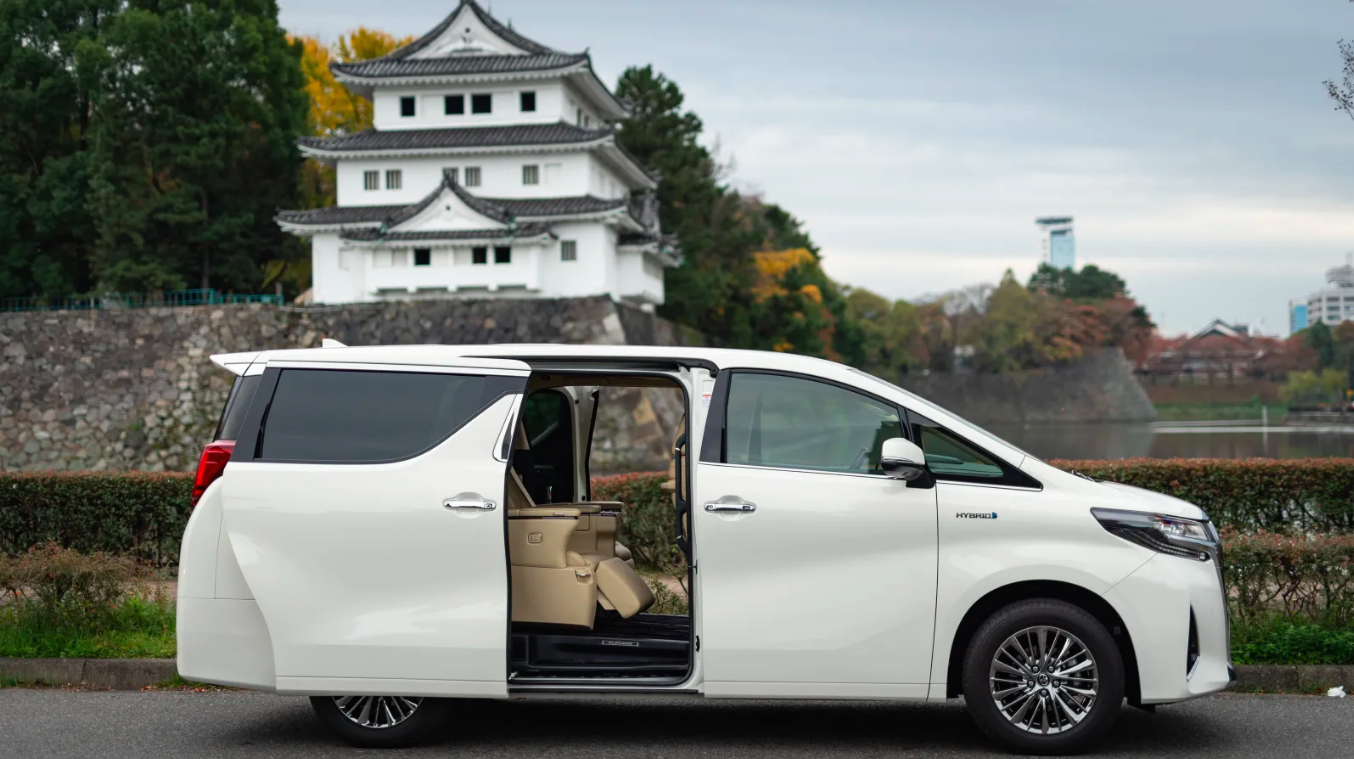 A Toyota Alphard in front of a pagoda in Japan.