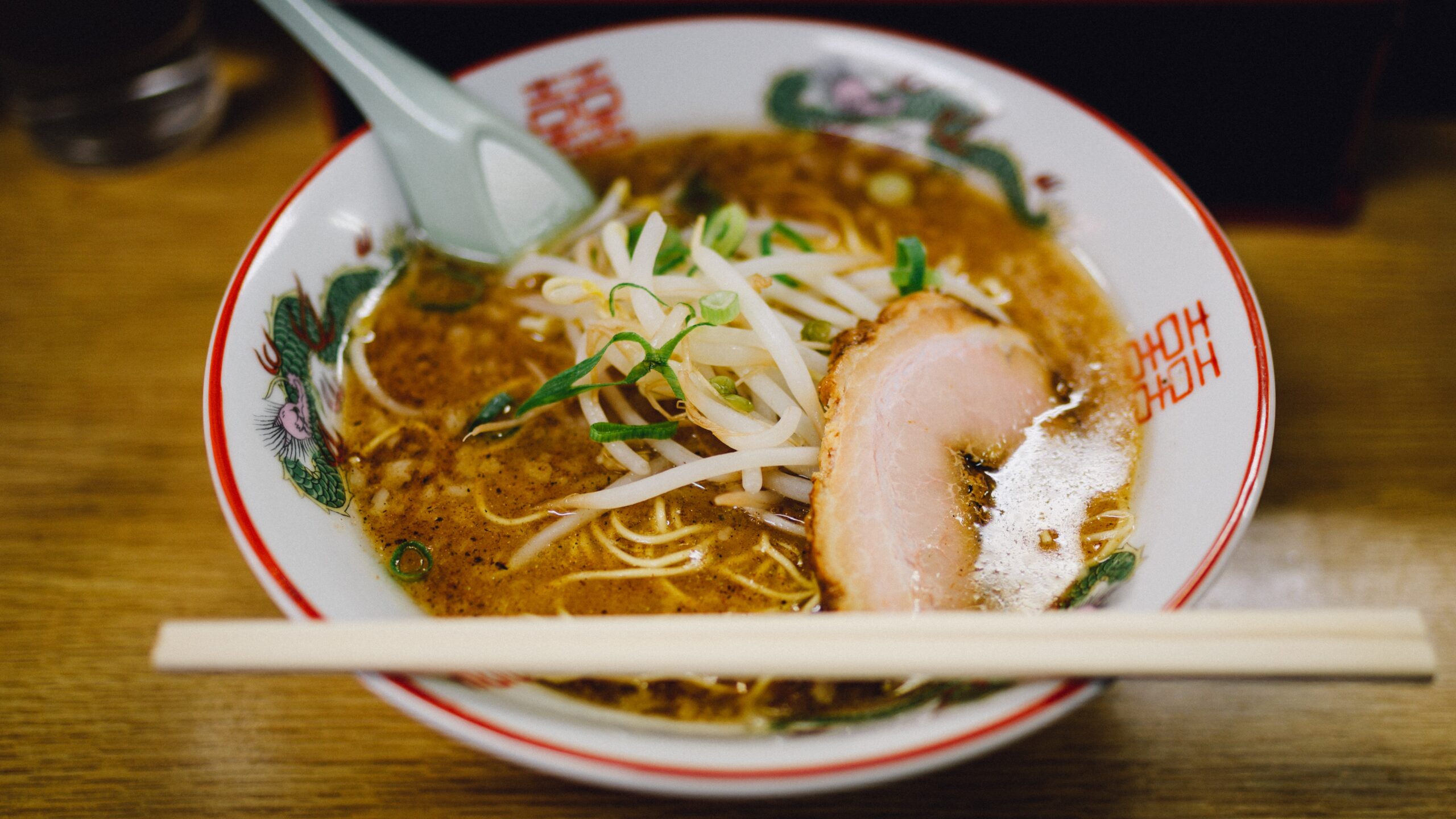 A hearty bowl of miso ramen with pork and sprouts.